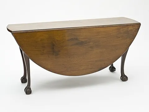 drop-leaf table: a table having a hinged section that can be fixed in a horizontal position to extend the table and...