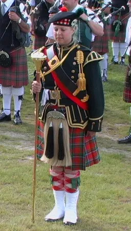 drum major: one who conducts and commands a marching band