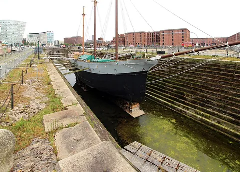 drydock: a dock that can be drained of water and is used in the repair and construction of ships