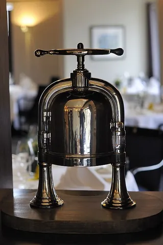 duck press: a machine used to extract the blood and bone marrow from a duck for use in pressed duck