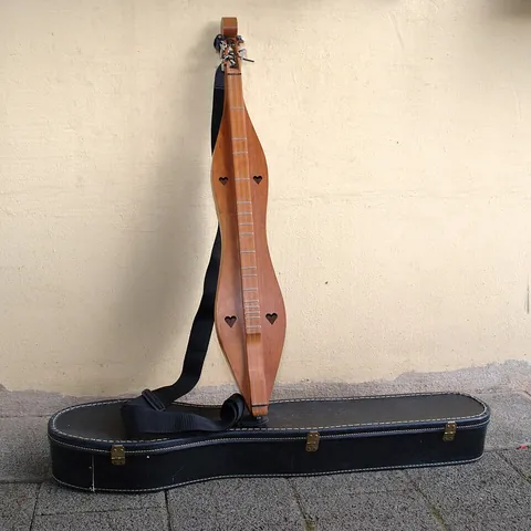 dulcimer: a stringed instrument, with strings stretched across a sounding board, usually trapezoidal, played...