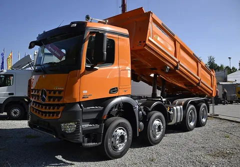 dump truck: a heavy truck, for carrying loose, bulk cargo (e.g., soil, gravel, grain), having a hinged bed that...