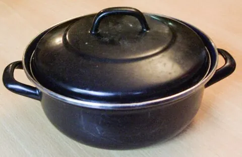 dutch oven: a large cooking pot with a tight-fitting lid, especially one made of metal