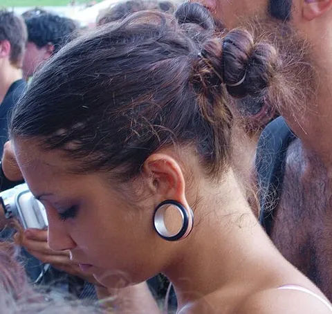 ear gauge: a piece of jewelry worn in a stretched ear piercing to maintain its size