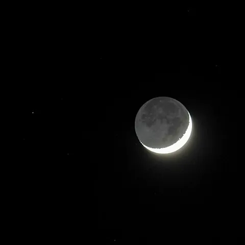 earthshine: sunlight reflected from the Earth's surface, especially when visible on the part of the Moon's...