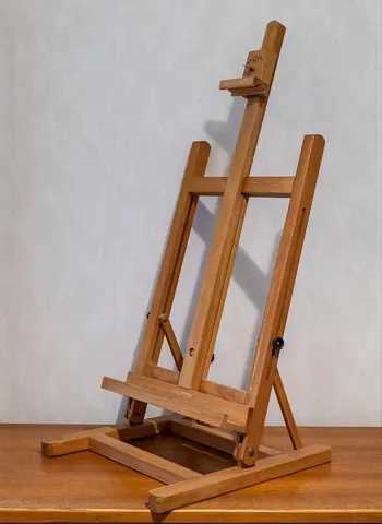 easel: an upright frame, typically on three legs, for displaying or supporting something, such as an...