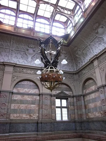 electrolier: a fixture, usually hanging from a ceiling, for holding electric lamps; specifically, a chandelier...