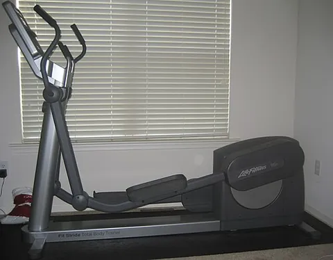 elliptical trainer: an exercise machine in which the feet of the user travel an elliptic path; used to simulate stair...