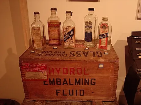 embalming fluid: a solution of various chemicals used to preserve cadavers prior to burial or cremation