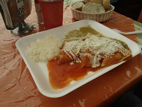 enchilada: a Mexican dish made by wrapping a filling in a tortilla, then baking in a sauce