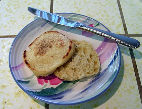 english muffin: a flat, round, yeast-leavened form of bread