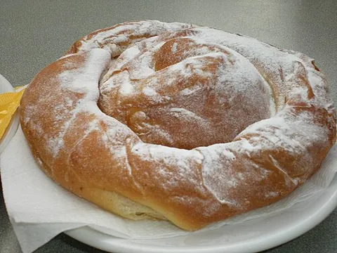 ensaimada: a type of pastry originating from Mallorca made from flour, water, sugar, eggs, dough and reduced...