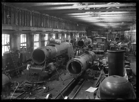 erecting shop: a place where large machines, predominantly trains and their parts but also cranes, are assembled,...