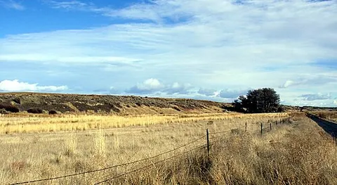 esker: a long, narrow, sinuous ridge created by deposits from a stream running beneath a glacier