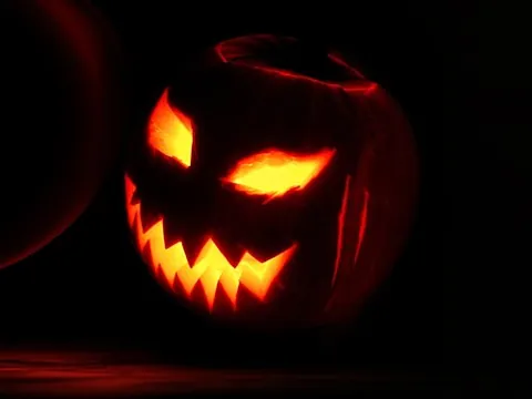 jack-o'-lantern: a carved pumpkin whose top and stem have been cut out and interior removed, leaving a hollow shell...