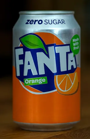 fanta: a brand of fruit-flavoured carbonated drink produced by the Coca-Cola Company