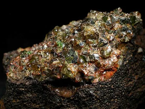 fayalite: yellow, olive green, brown or black mineral with orthorhombic crystals of the olivine group, Fe₂SiO₄