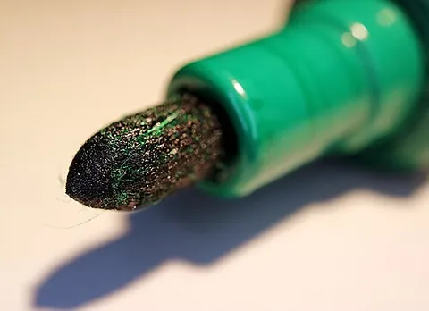 felt-tip pen: a pen that holds quick-drying ink conveyed to a writing surface by means of a felt nib