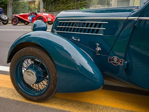 fender: panel of a car which encloses the wheel area, especially the front wheels