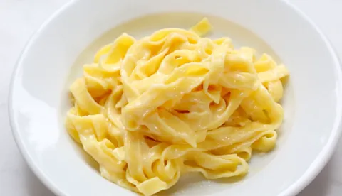 fettuccine alfredo: fettuccine pasta served with a sauce containing cream, parmigiano, nutmeg and pepper