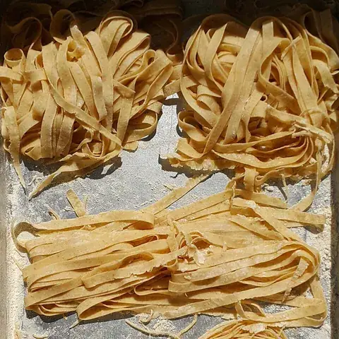 fettuccine: long, flat ribbons of pasta, cut from a rolled-out sheet; identical in form to tagliatelle