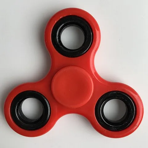 fidget spinner: a type of stress-relieving toy that is intended to be spun around in one's hand, and that generally...