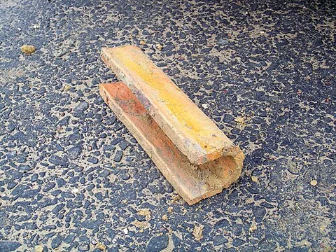 field tile: a type of hollow clay drainage pipe laid end to end mainly in agricultural fields, with a small gap...