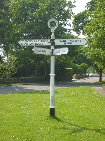 fingerpost: a board that shows the direction (and often distance) to a named place; especially one of several...