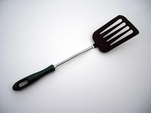 fish slice: a kitchen utensil used to turn foodstuffs (commonly, burgers and omelettes) in a frying pan; a...