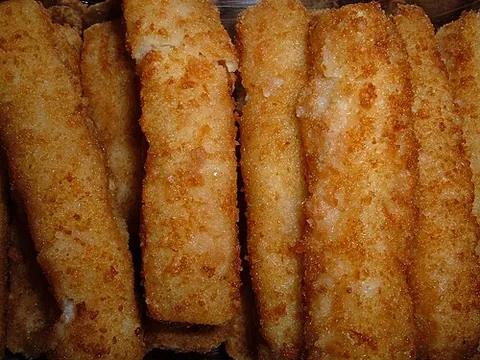 fish stick: a rectangular piece of processed fish coated in breadcrumbs that is cooked by frying or grilling