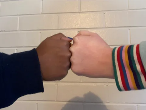 fist bump: the hitting together of two people's fists, as a greeting, in congratulations, or in celebration