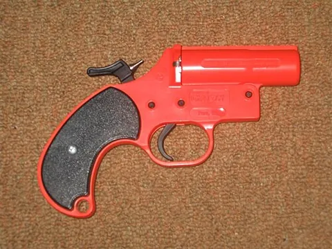 flare gun: a large-bore pistol-like firearm used to fire signal flares
