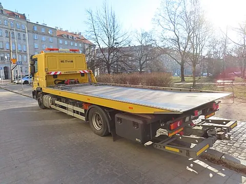 flatbed truck: a truck with no sides, used to carry large, heavy objects