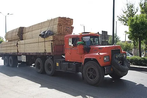 flatbed: an open freight vehicle with no sides, designed to carry heavy or outsized loads