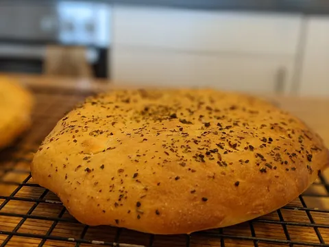 flatbread: a thin, flat bread, often made from unleavened dough