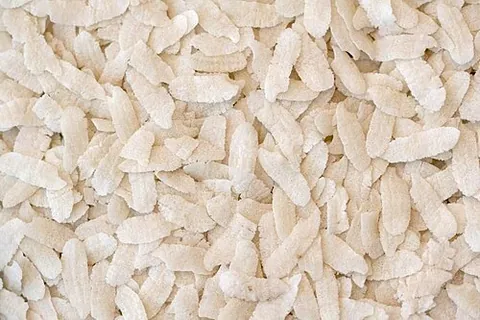 flattened rice: rice that has been pounded into flat flakes; a common staple in South and Southeast Asia