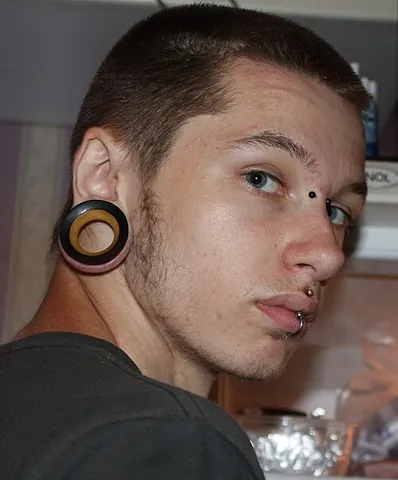flesh tunnel: a piercing in the earlobe which has been deliberately stretched to achieve a larger gauge
