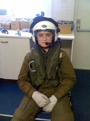flight suit: a warm, durable full-body garment designed to be worn while flying an aircraft