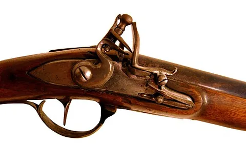flintlock: an early type of firearm, using a spring-loaded flint to strike sparks into the firing pan