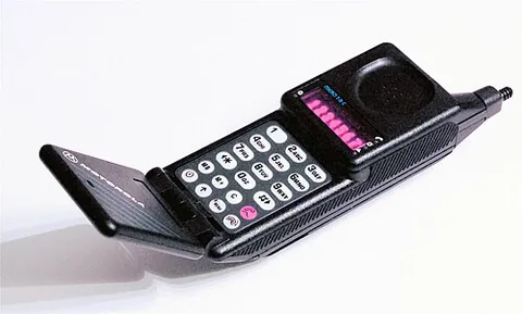 flip phone: a mobile telephone with a hinged top that is flipped open when the phone is in use