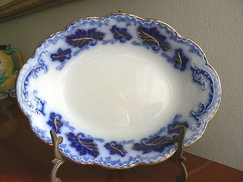 flow blue: a style of white earthenware, sometimes porcelain, that originated in the Regency era among the...