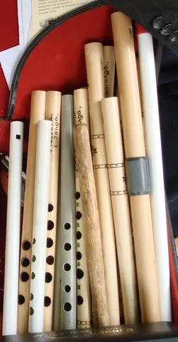 flute: a woodwind instrument consisting of a tube with a row of holes that produce sound through...