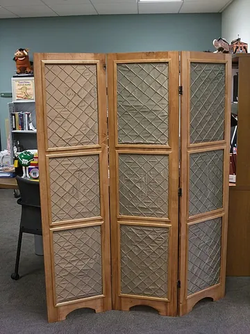 folding screen: a piece of furniture consisting of two or more frames connected by hinges