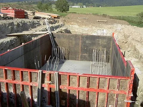 formwork: a temporary mold, made from planks, into which concrete is poured