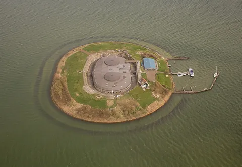 fort: a fortified defensive structure stationed with troops