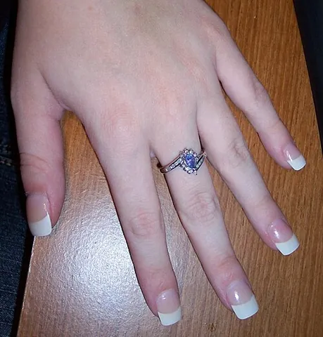 french manicure: a manicure that involves painting the tip of the nails with a band of white polish