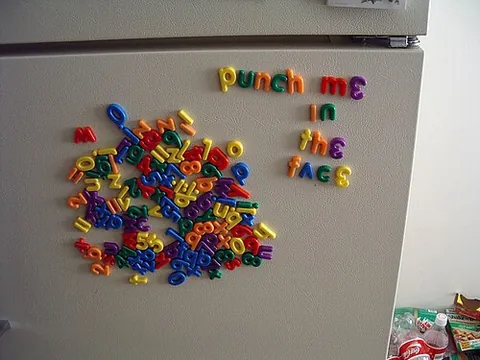 fridge magnet: a decoration attached to a magnet, displayed on the outside of refrigerator doors, sometimes used...