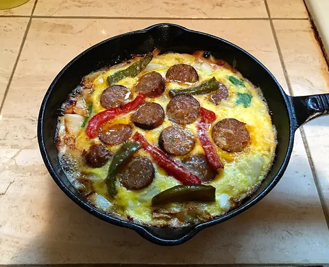 frittata: a crustless quiche: a molded omelette in which vegetables, cheese, etc., are mixed into the eggs...