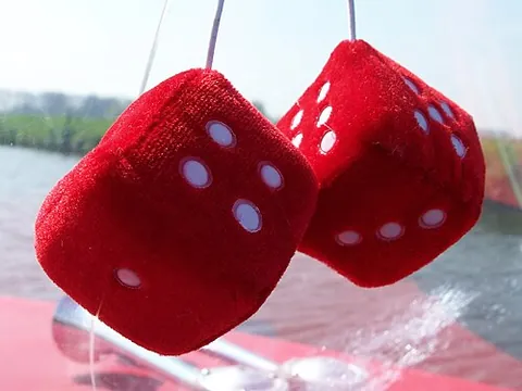 fuzzy dice: an automotive decoration, first used in the 1950s, consisting of two oversized (usually six-sided)...