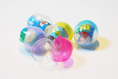 gacha: a small toy sold in a plastic capsule in a vending machine, especially toys sold in or associated...